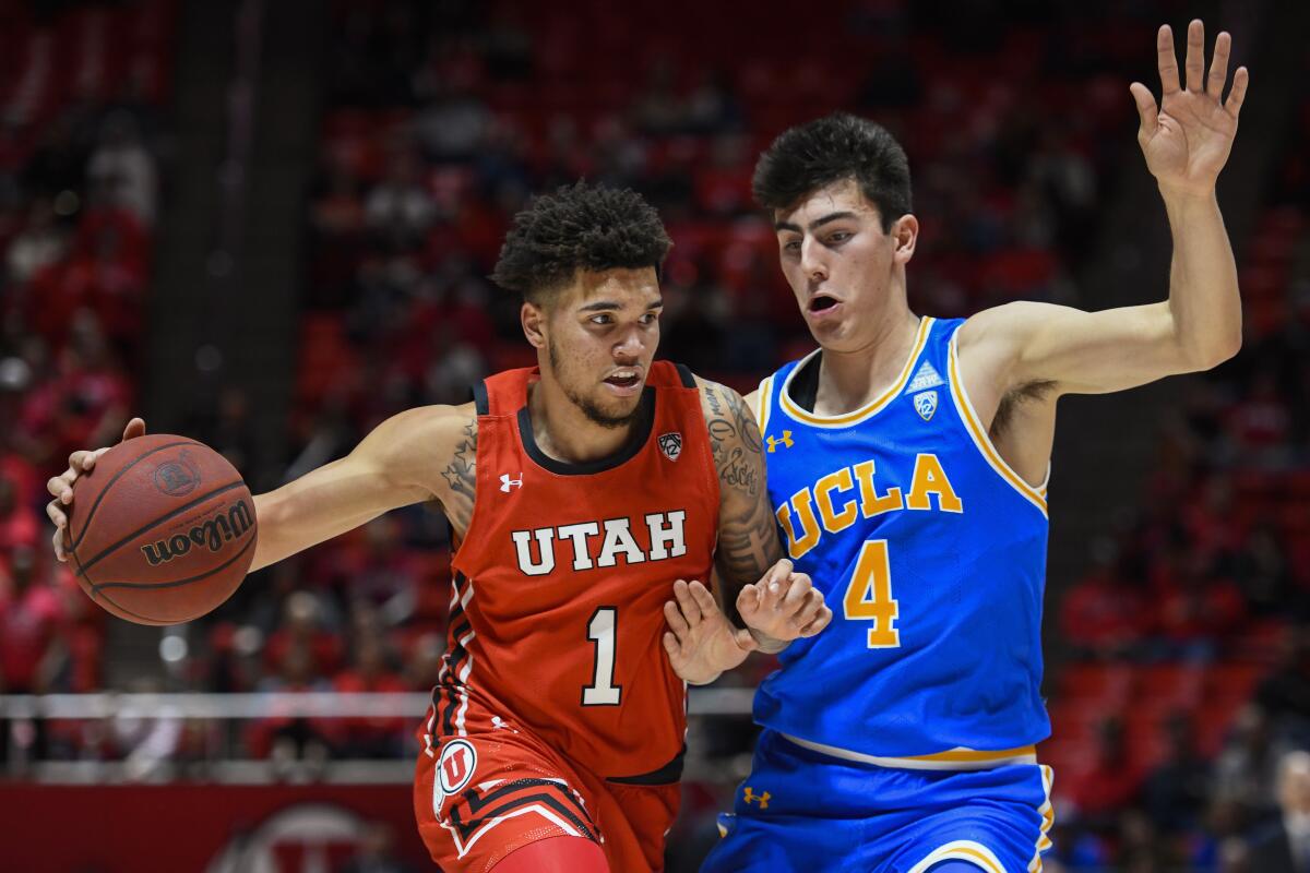 Utah forward Timmy Allen tries to drive past UCLA guard Jaime Jaquez Jr. during the second half of a game Feb. 20 at Jon M. Hunstman Center.
