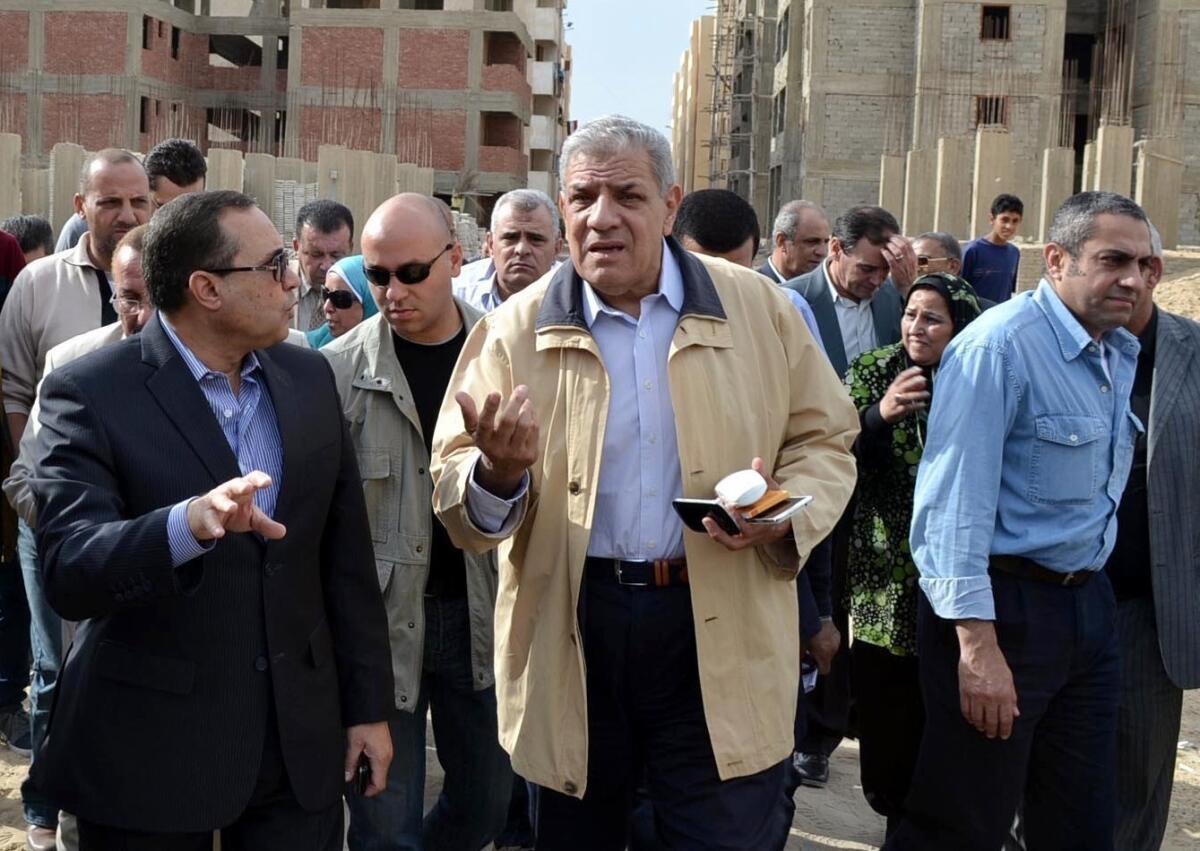 Ibrahim Mehlib, Egypt's former housing minister, center, tours a government housing project in Ismailiya in November 2013. Egypt's interim president has named Mehlib as the country's new prime minister.