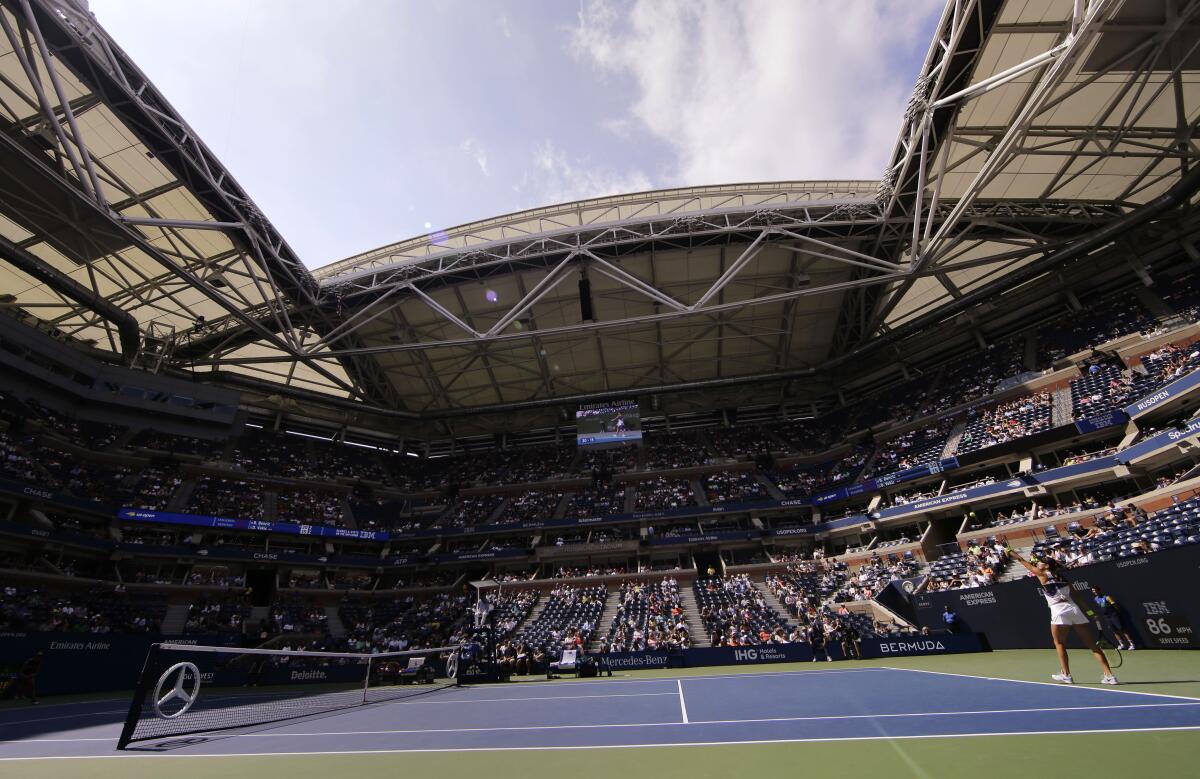 FILE - Daylight streams in from the open roof of Arthur Ashe Stadium as Donna Vekic, of Croatia, serves against Belinda Bencic, of Switzerland, during the quarterfinals of the U.S. Open tennis championships on Sept. 4, 2019, in New York. The U.S. Open singles champions will receive $2.6 million this year, with total player compensation for the Grand Slam tournament surpassing $60 million for the first time. (AP Photo/Frank Franklin II, File)