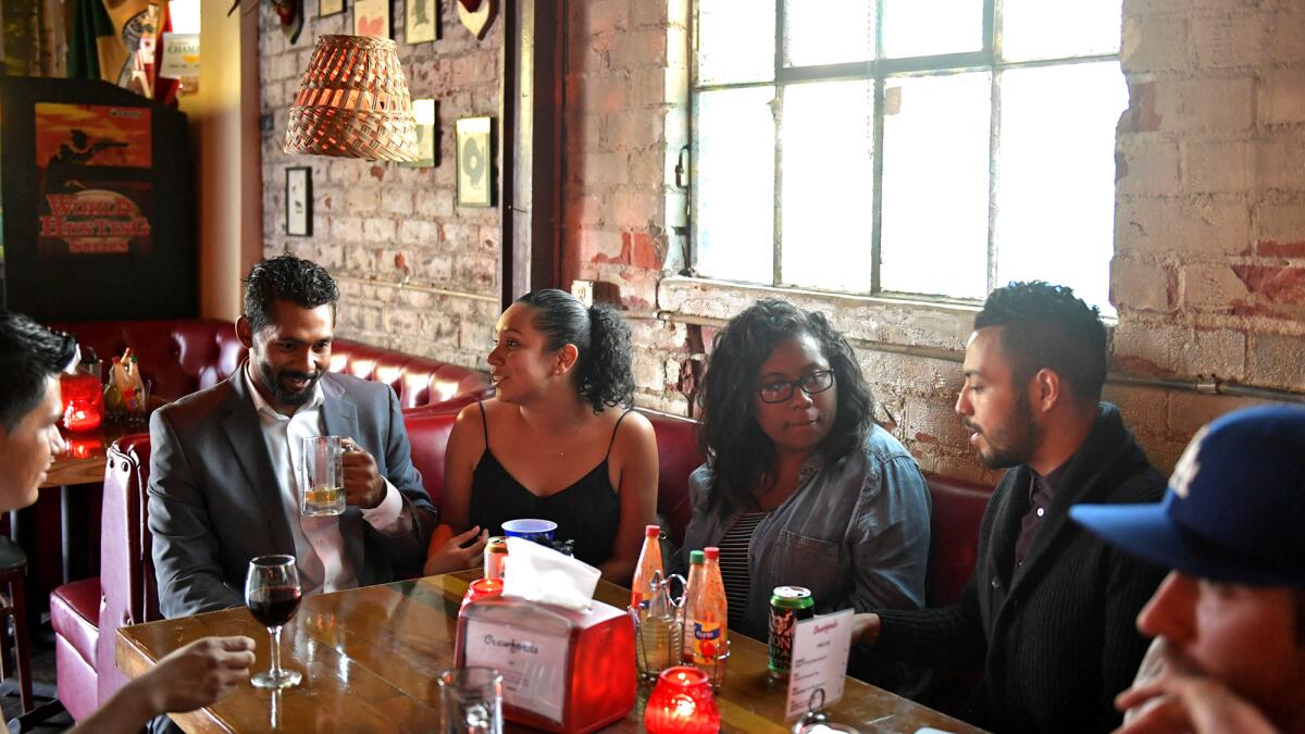 Concierges Mamie Burton and Sabrina Fuentes of HoM accompany residents at an outing at Crawford's Bar.