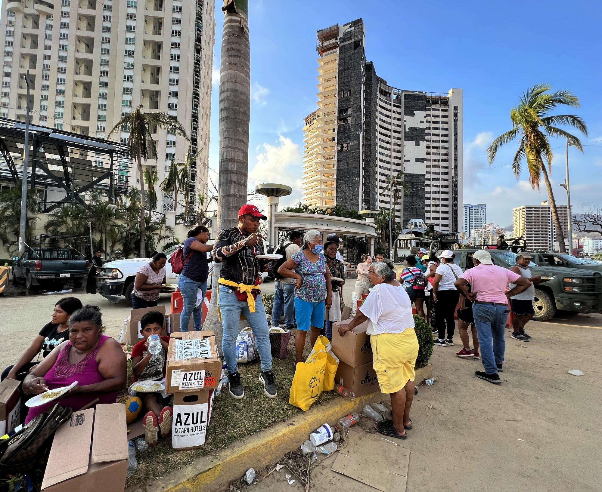 Acapulco residents line up for food.