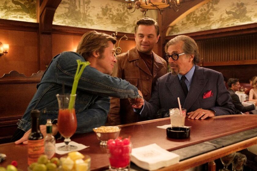***SUMMER SNEAKS 2019**DO NOT USE PRIOR TO APRIL 28, 2019***Brad Pitt, Leonardo DiCaprio, Al Pacino star in Columbia Pictures “Once Upon a Time in Hollywood". The trio are filmed inside Musso & Frank Grill which got a nostalgic makeover. We did an enormous amount of research,” says production designer Barbara Ling. “The main thing was to keep ourselves captured in a specific time frame in terms of graphics and ads and what, specifically, the buildings looked like. We wanted to be very close to what it was like in that summer in that year. The advertising was unique — what was on the billboards in that summer, at that time. The production took over parts of Hollywood Boulevard and Sunset Boulevard with the permission of the building owners and businesses, and built the storefronts as they looked in 1969. Ling replaced the famous mural that used to appear on the side of the Aquarius Theatre on Sunset, and a few existing businesses, including the Cinerama Dome and Musso & Frank Grill, got a nostalgic makeover.