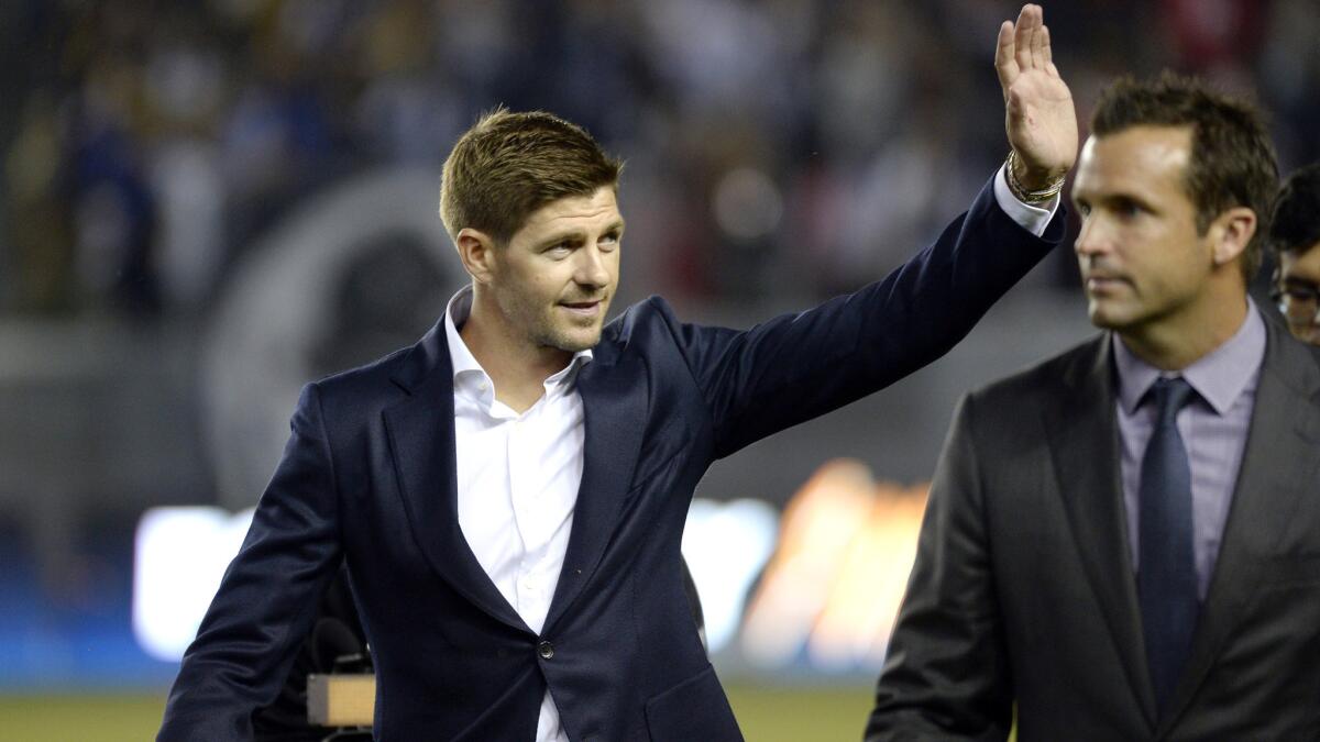Steven Gerrard waves to the crowd as he's introduced to Galaxy fans at halftime of their game against Toronto on Saturday night at StubHub Center.