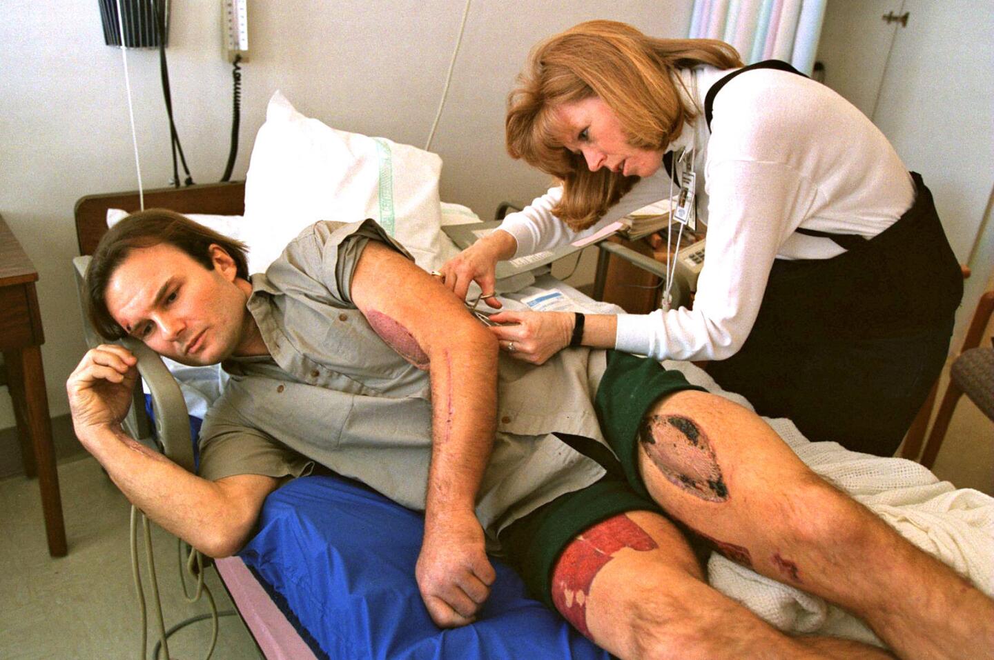 Alan Hemsath has the final stitches removed from his arm by registered nurse Nancy Chicca before being discharged from St. Joseph Medical Center on Feb. 12, 1994. Hemsath was the last victim to be pulled out alive from the collapsed Northridge Meadows apartment complex and the only first-floor resident to survive.