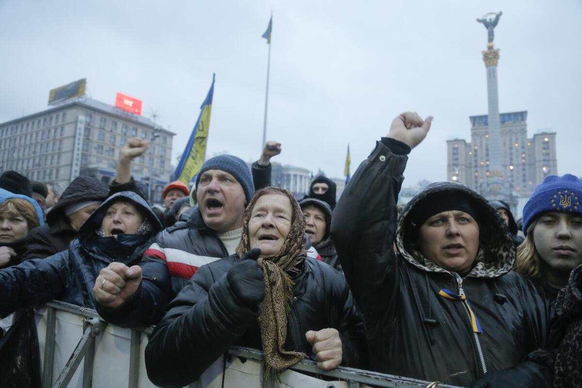People raise their fists during a rally in Independence Square, Kiev, the epicenter of Ukraine's unrest.