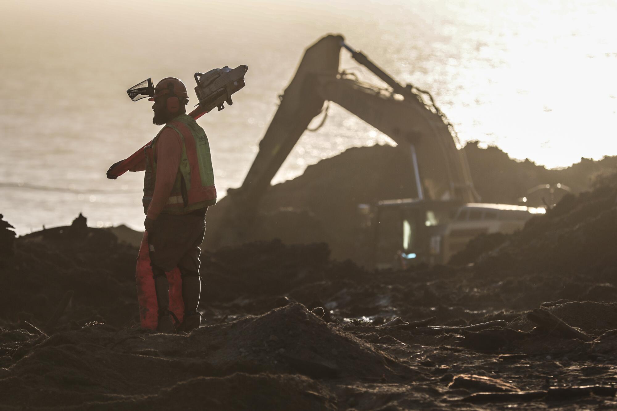 A man stands by the coast.