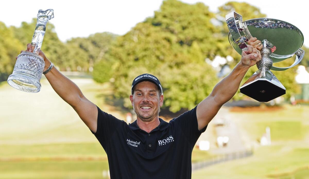 Henrik Stenson of Sweden poses with the Tour Championship and FedEx Cup trophies after winning both on Sunday.