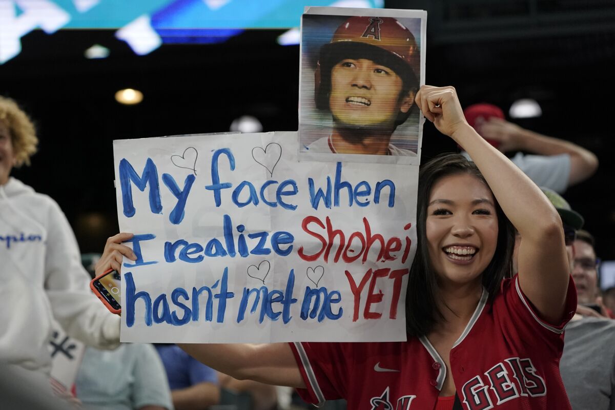 A fan holds a sign for Los Angeles Angels star Shohei Ohtani