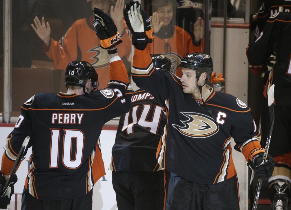 Ryan Getzlaf, right, and Corey Perry celebrate the Ducks' 6-3 win over the Calgary Flames on Jan. 21. They will try to replicate the feat Thursday night in Game 1 of their playoff series.