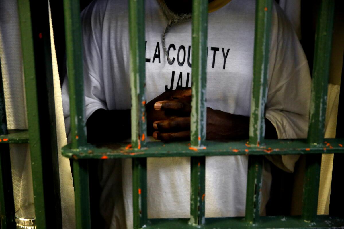 A jail inmate behind bars.