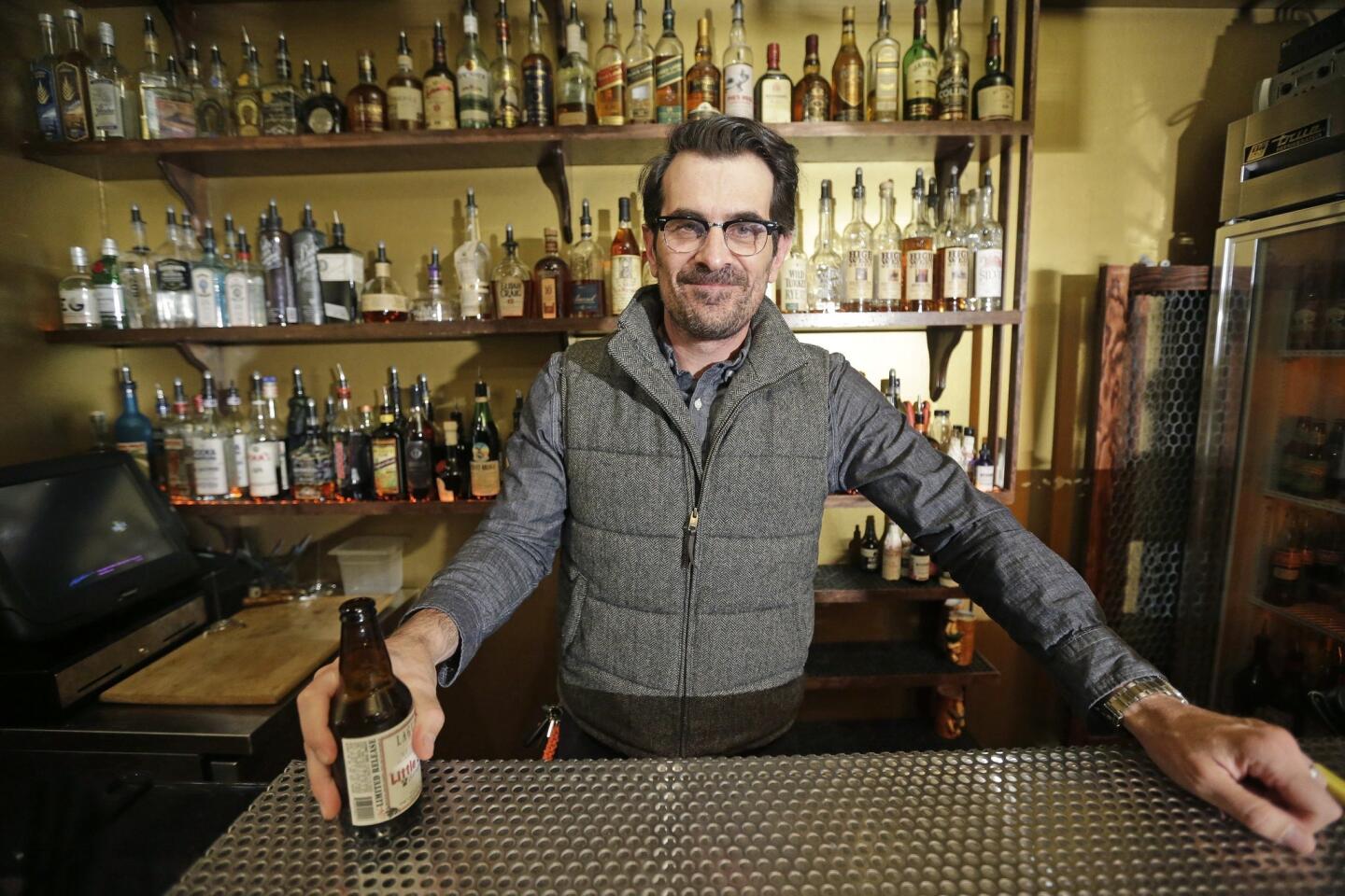 Ty Burrell poses with a beer at the bar he co-owns in Salt Lake City, Bar-X.