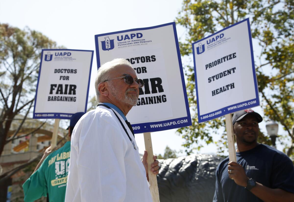 Dr. Stuart Bussey pickets outside the student health center at UCLA on April 11.