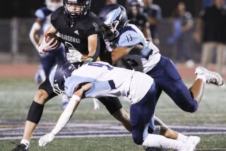 San Diego, CA - September 23: Madison's Jake Jackson (3) is taken down by Granite Hills' Easton Peterson (9) and Nokoi Maddox (13) during their game at Madison High School on Friday, Sept. 23, 2022 in San Diego, CA. (Meg McLaughlin / The San Diego Union-Tribune)