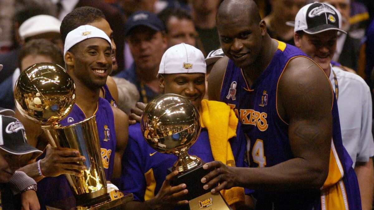 Lakers teammates Kobe Bryant, Lindsey Hunter and Shaquille O'Neal celebrate.