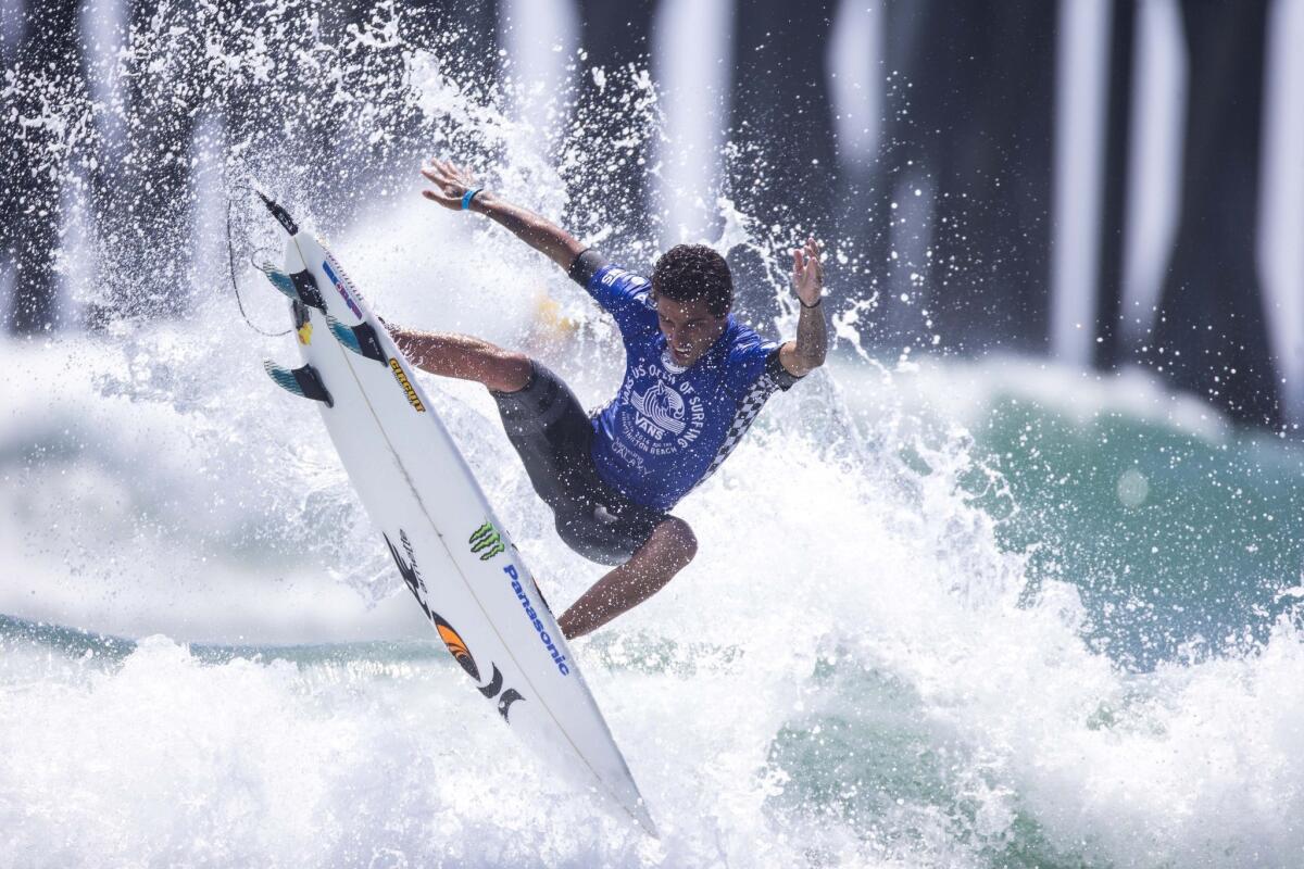 Filipe Toledo catches air as he cuts back off a wave during the men's final at the U.S. Open of Surfing on Sunday.