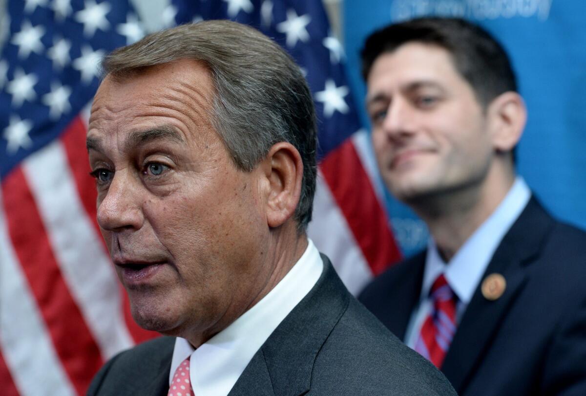 Republican House Speaker John A. Boehner speaks in front of Rep. Paul Ryan (R-Wis.) during a news conference on Capitol Hill.