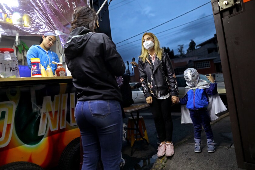 Monserat Mejia brings her 3-year-old nephew Damian Robles to eat and meet El Último Guerrero at his food truck in Mexico City