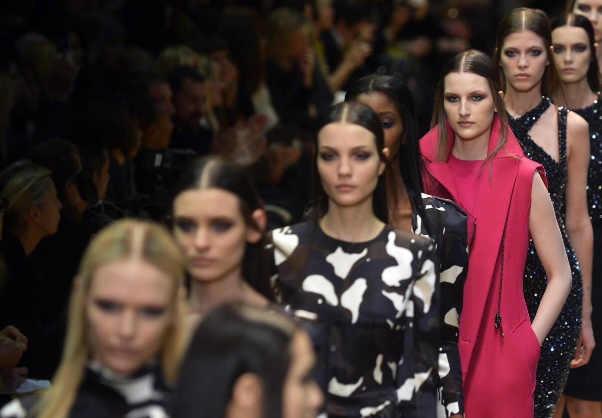 Models present creations by French fashion house Guy Laroche during Paris Fashion Week.