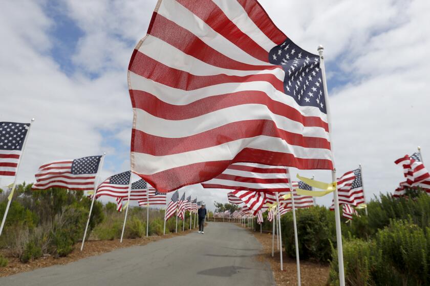 One of 1,776 large American flags, waives in the wind during the Exchange Club of Newport Harbor's 13th annual Field of Honor at Castaways Park in Newport Beach. The weeklong presentation of flags recognizes the service and sacrifice of military personnel and ends with a ceremony with guest speakers, honored guests, and the playing of "taps" on Memorial Day this Sunday.