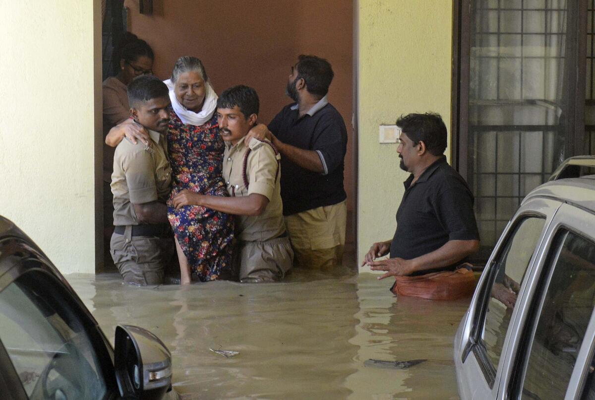 Firefighters rescue an elderly woman from a flooded apartment after heavy rainfall in Bangalore, India, Monday, Sept. 5, 2022. Life for many in the southern Indian city of Bengaluru was disrupted on Tuesday after two days of torrential rains set off long traffic snarls, widespread power cuts and heavy floods that swept into homes and submerged roads. (AP Photo/Kashif Masood)