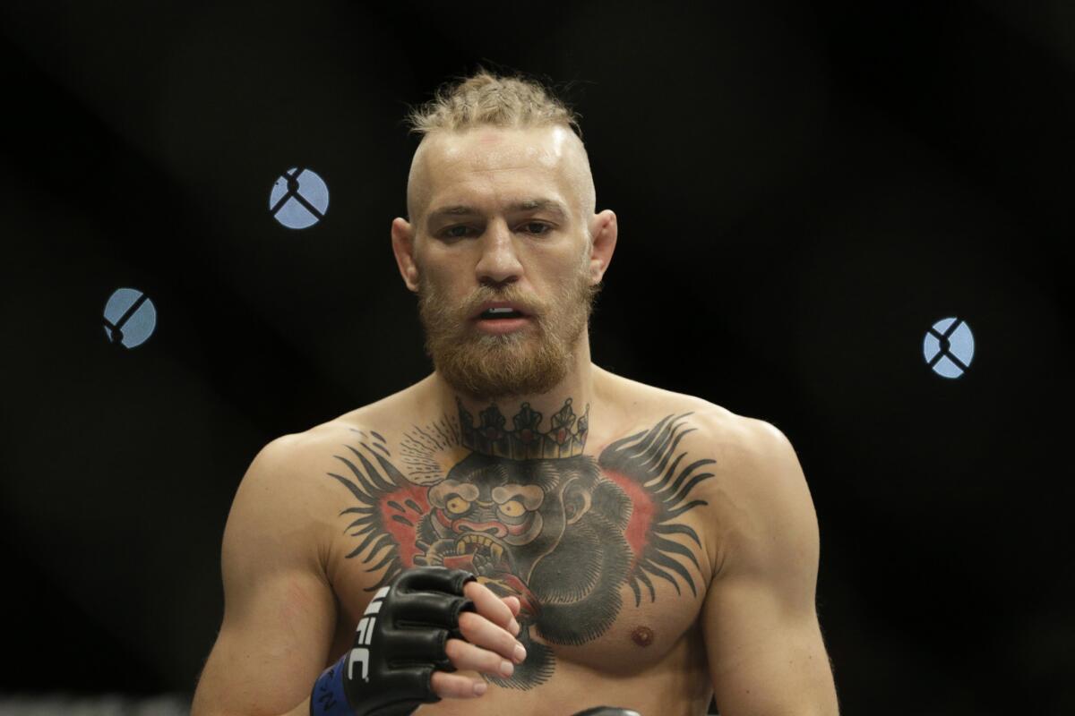 UFC fighter Conor McGregor will fight Jose Aldo for the featherweight title on July 11 in Las Vegas. The Irishman grabbed the belt away from the champion Tuesday during a news conference.
