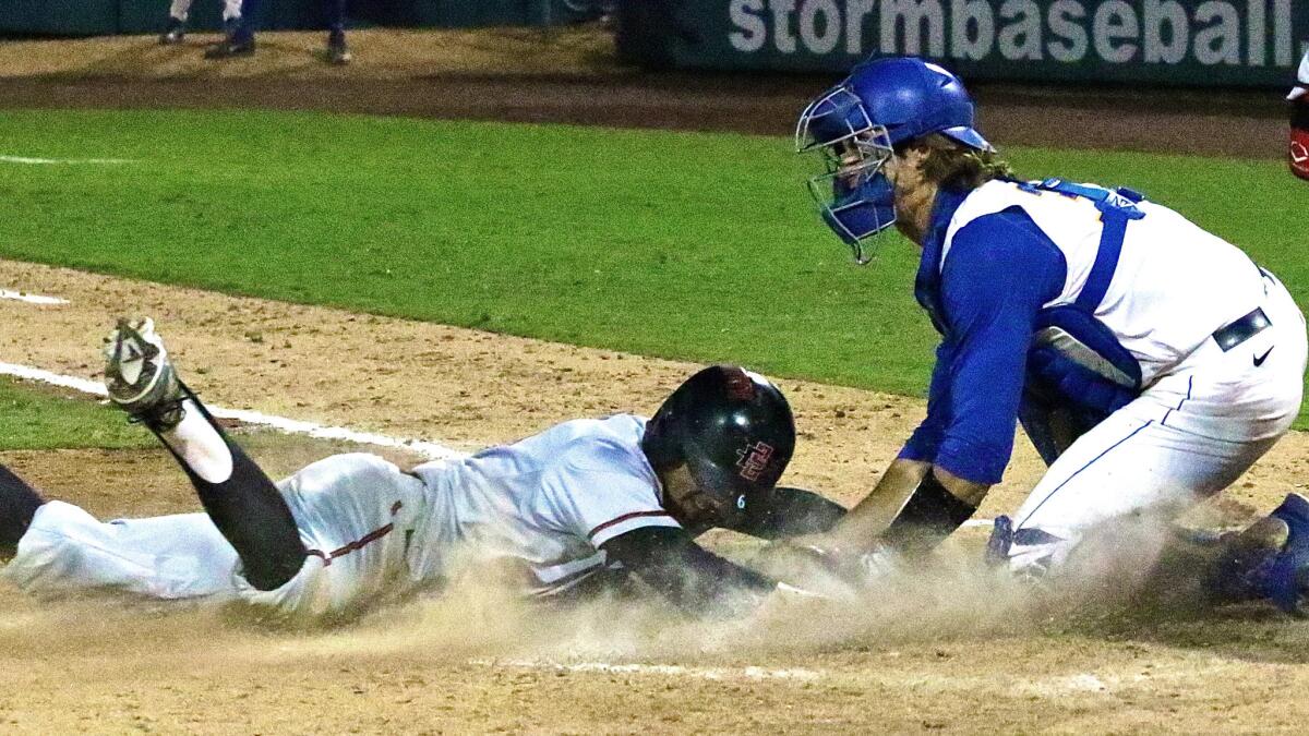 San Diego State first baseman Steven Pallares steals home before UC Santa Barbara catcher Campbell Wear can apply the tag.