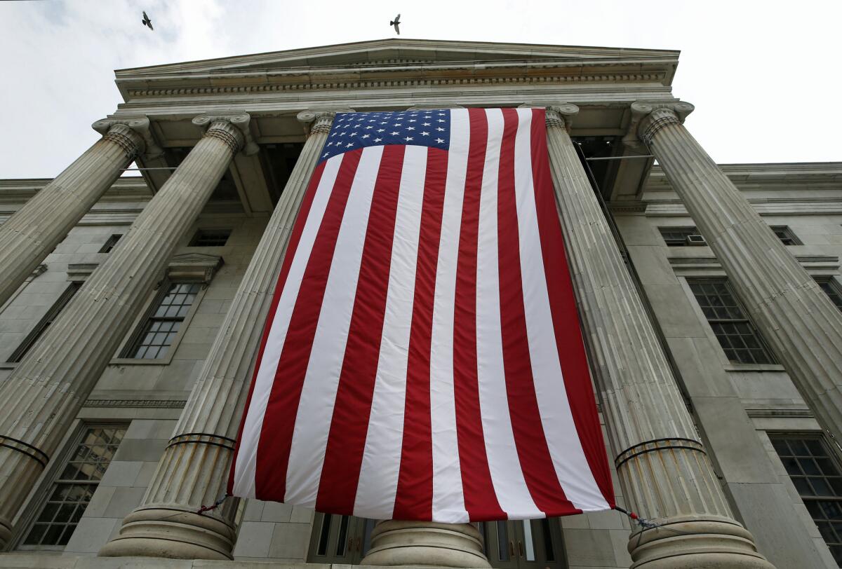 A giant American flag hangs from the front of Brooklyn's Borough Hall on Thursday, the day before the U.S. celebrates its freedom.