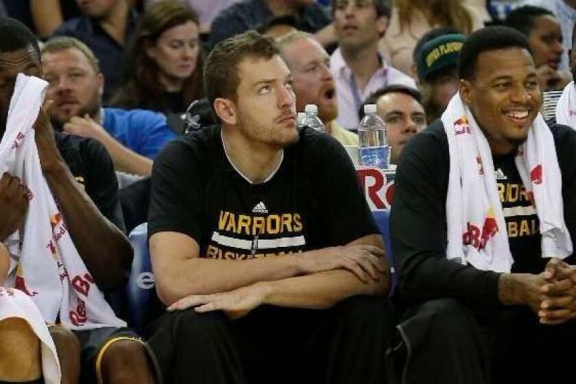 In this March 14, 2015, photo, Golden State Warriors forward David Lee, center, sits on the bench during the first half of an NBA basketball game against the New York Knicks in Oakland, Calif. There are days David Lee plays enough minutes he can find a flow, then others when the former All-Star forward never leaves Golden State's bench. It's one of the hardest decisions first-year coach Steve Kerr has made while leading the Western Conference's hottest team, and even harder for Lee. (AP Photo/Jeff Chiu) ORG XMIT: CAJC201