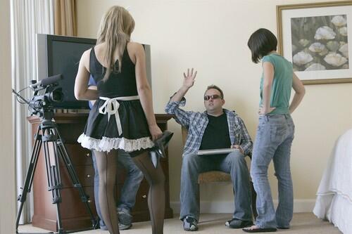 Director Tim Street, seated, talks to the cast members of "French Maid TV." Read the story.