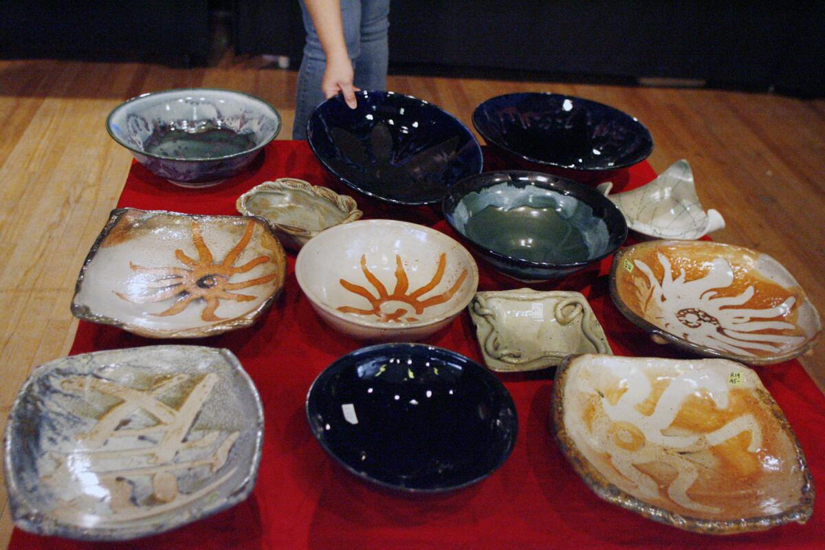 File Photo: Lori Tsaparian, photographed in December 2011, takes a look at ceramic bowls during the ceramics sale, which takes place each year at La Cañada Flintridge Community Center.