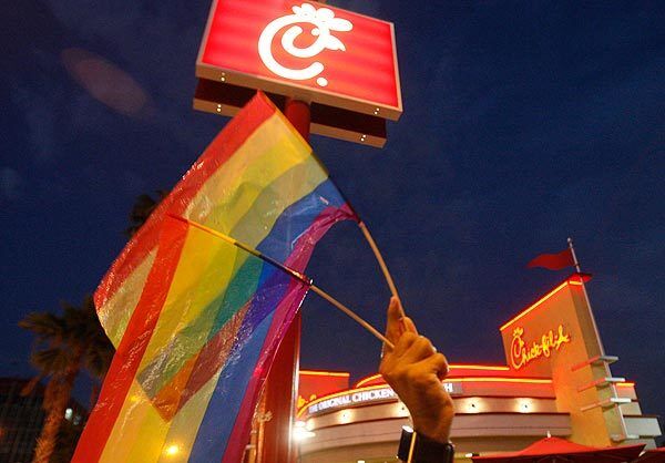 Gay pride flags are held up during protest in front of the Hollywood Chick-fil-A restaurant.