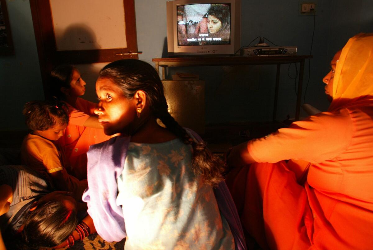 In a 2004 photo, women at a New Delhi shelter for victims of dowry violence view a video recounting the persistent problem of in-laws resorting to violence against young brides to extort more dowry from their parents. The upward trend in dowry deaths continues despite modernization in the country.