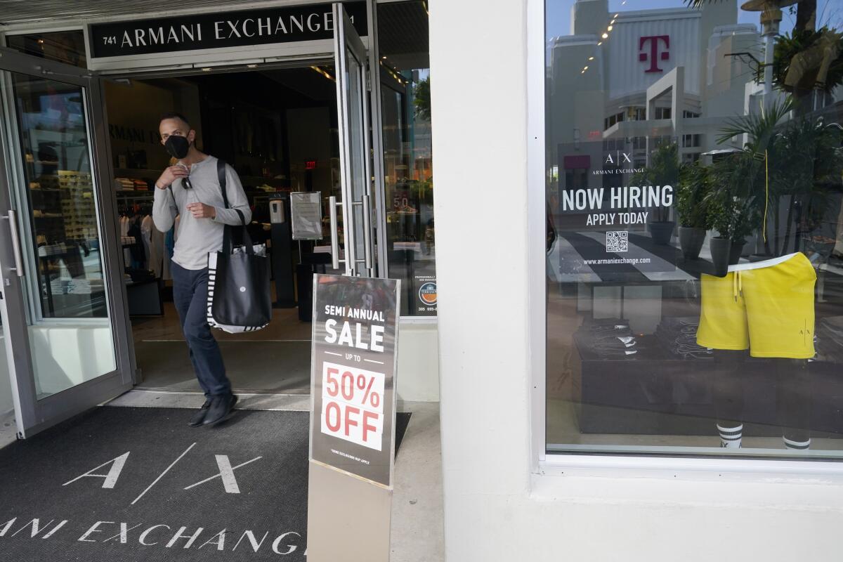 For sale and hiring signs are displayed at an Armani Exchange store