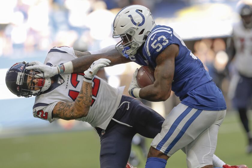 INDIANAPOLIS, IN - OCTOBER 20: Darius Leonard #53 of the Indianapolis Colts puts the stiff arm on Kenny Stills #12 of the Houston Texans after an interception late in the fourth quarter sealing the game for the Colts at Lucas Oil Stadium on October 20, 2019 in Indianapolis, Indiana. (Photo by Michael Hickey/Getty Images)