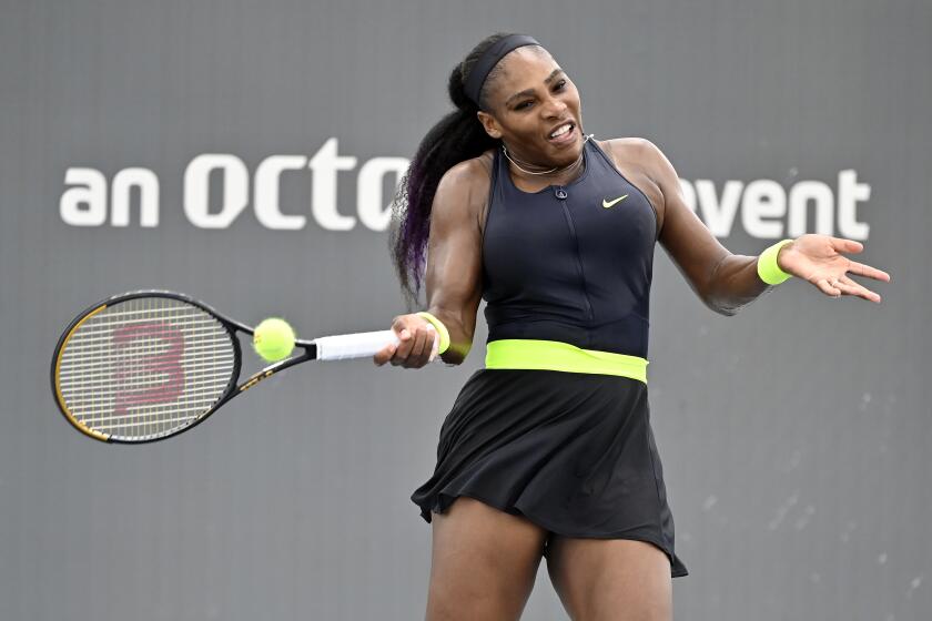 Serena Williams returns a shot to her sister Venus Williams during the WTA tennis tournament in Nicholasville, Ky., Thursday, Aug. 13, 2020. (AP Photo/Timothy D. Easley)