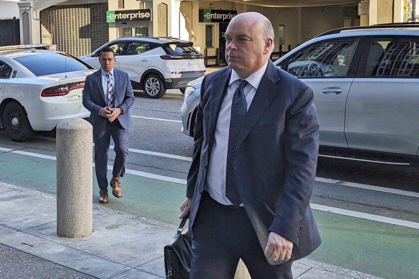 FILE - Former British tech star Mike Lynch walks into federal court in San Francisco for another day of a criminal trial accusing him of ripping off Hewlett Packard in an $11 billion acquisition of software maker Autonomy, March 26, 2024. On Thursday, June 6, Lynch, once hailed as Britain’s king of technology, was cleared of charges alleging he orchestrated a fraud and conspiracy leading up to an $11 billion deal that turned into a costly albatross for Silicon Valley pioneer Hewlett Packard. (AP Photo/Michael Liedtke, File)
