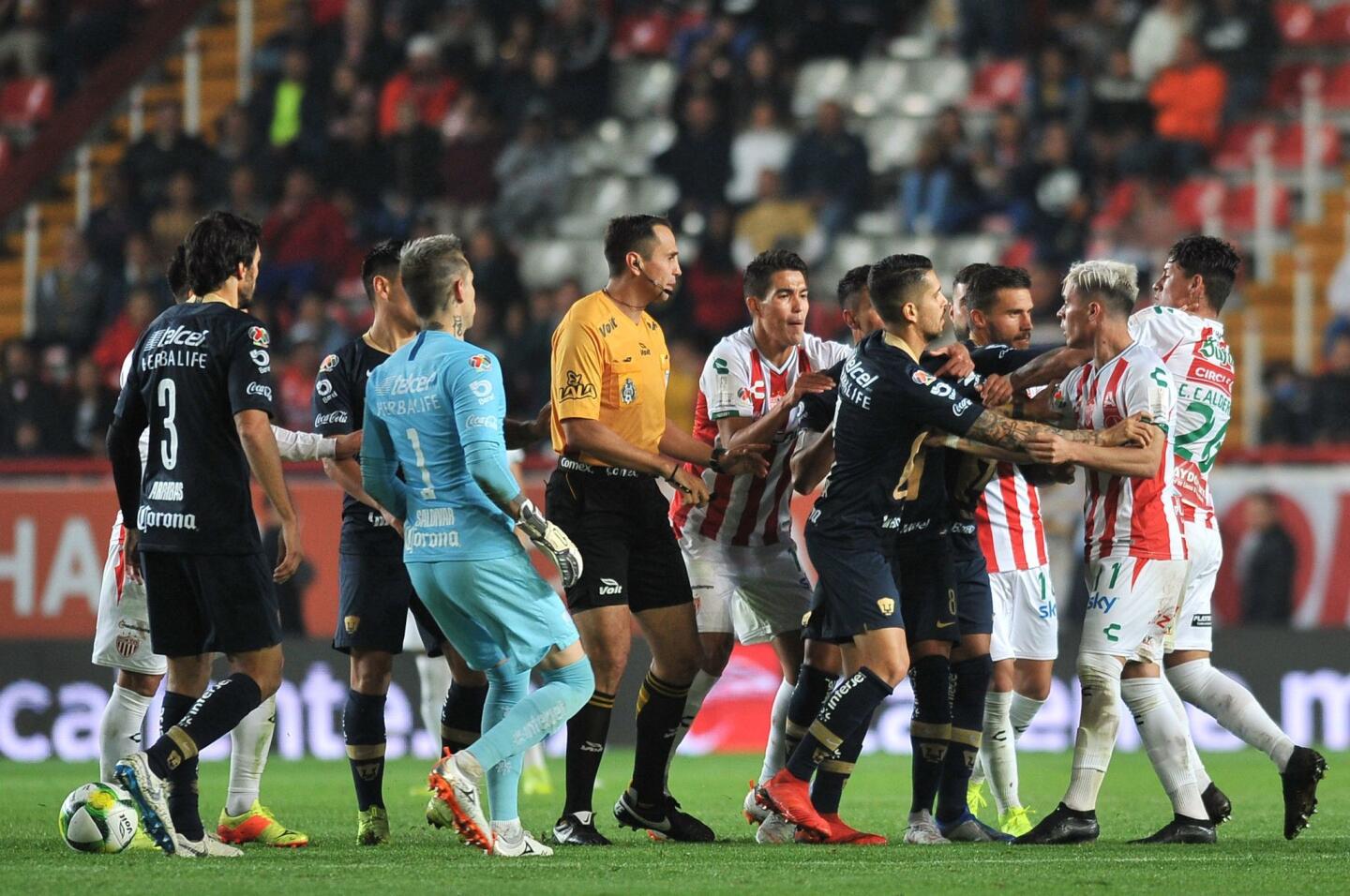 Necaxa's players argue with Pumas's players during the Mexican Clausura 2019 tournament football match between Necaxa and Pumas UMAN at Victoria Stadium in Aguascalientes, Mexico, on January 12, 2019. (Photo by VICTOR CRUZ / AFP)VICTOR CRUZ/AFP/Getty Images ** OUTS - ELSENT, FPG, CM - OUTS * NM, PH, VA if sourced by CT, LA or MoD **