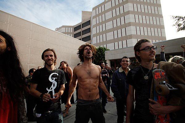 Shane, center, who gave no last name, and others shout out at Occupy L.A. protesters being released on Bauchet Street in downtown L.A.