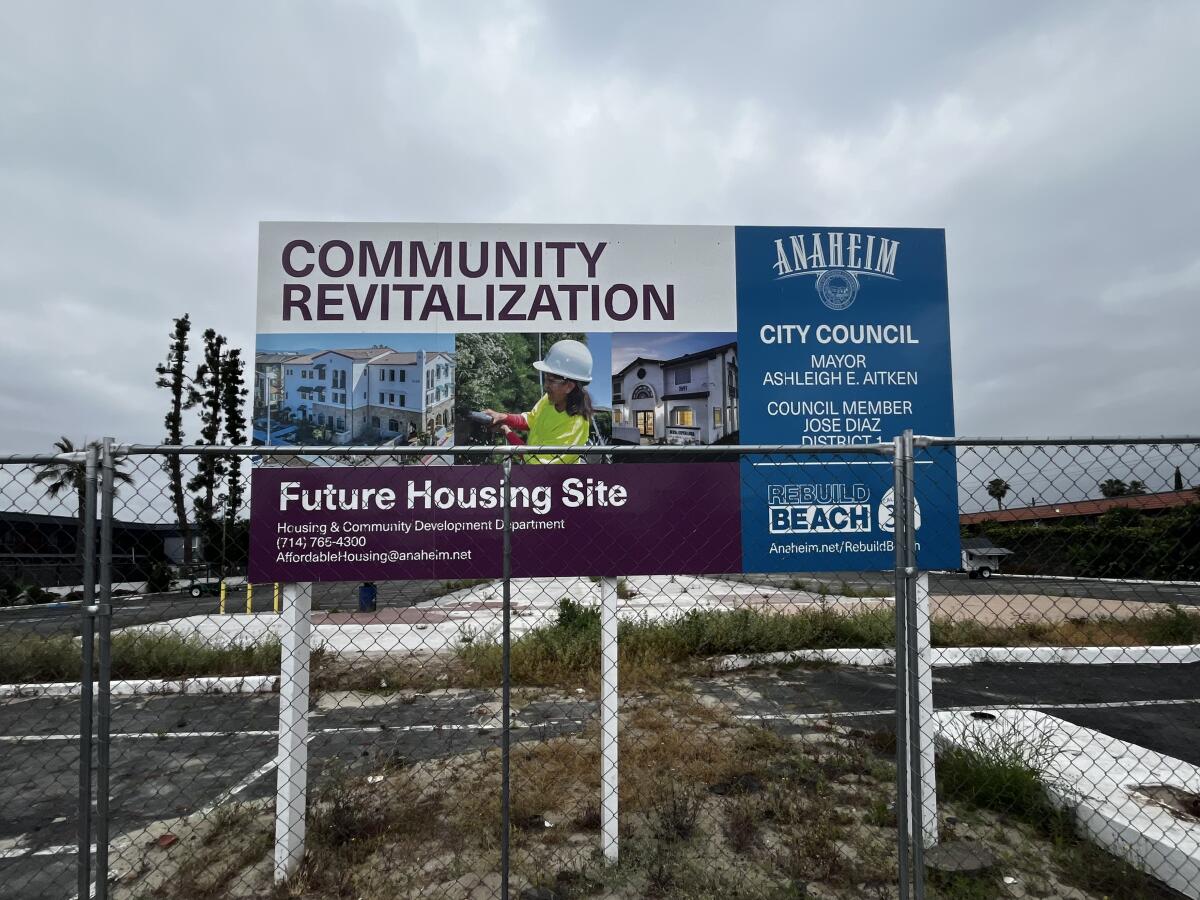 A sign promising future housing at the location of the former Covered Wagon motel.