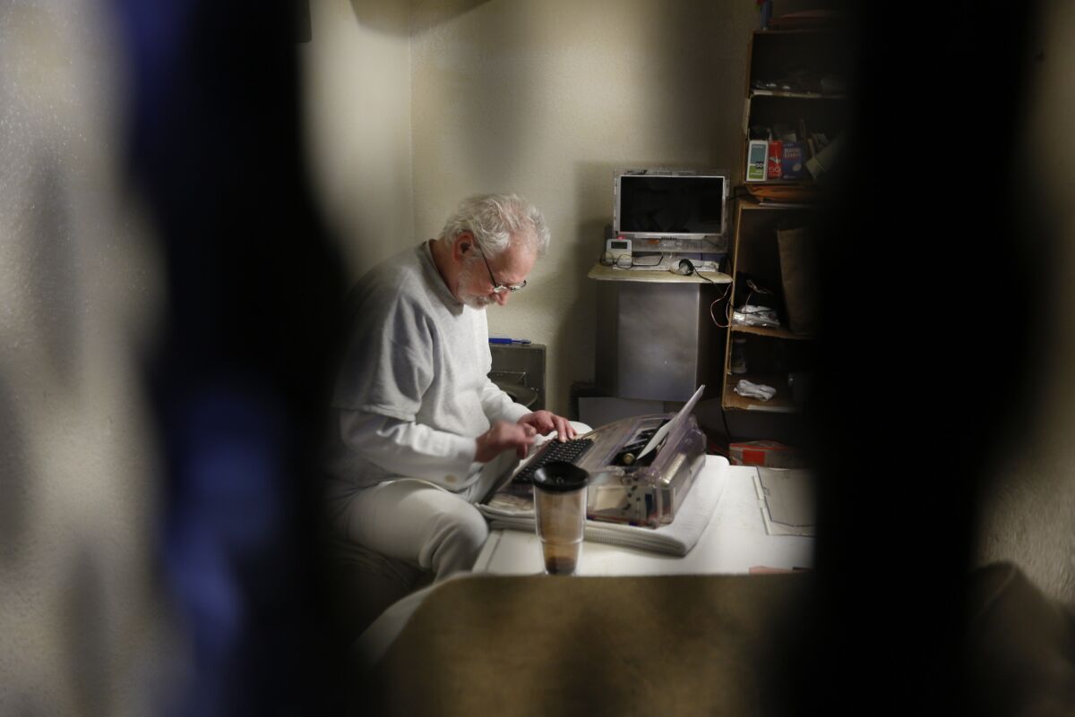 Condemned inmate Charles Case spends some of his time typing in his cell in the East Block at San Quentin prison.