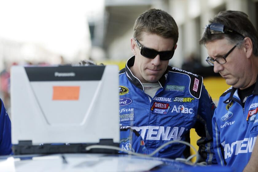 NASCAR driver Carl Edwards, left, will not be a member of Roush Fenway racing for the 2015 season, the team announced Sunday before the Brickyard 400 in Indianapolis.