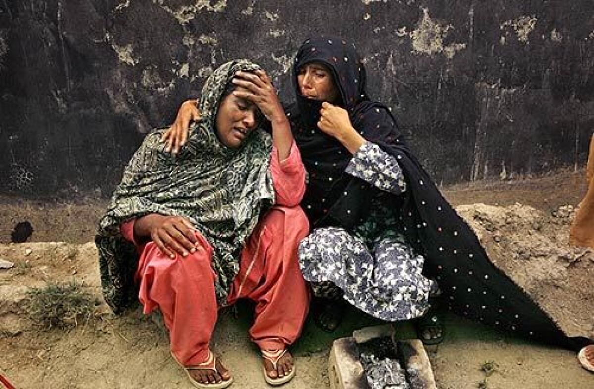 Women at the Sheik Yaseen displacement camp in Mardan, Pakistan, grieve for their relative who died of an illness exacerbated by the harsh living conditions in the camp.