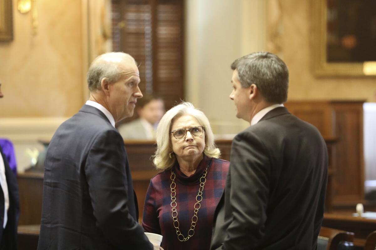Republican South Carolina Sen. Tom Corbin, left, Katrina Shealy, center, and Shane Massey speak before a special session on abortion on Tuesday, Oct. 18, 2022, in Columbia, S.C. (AP Photo/Jeffrey Collins)