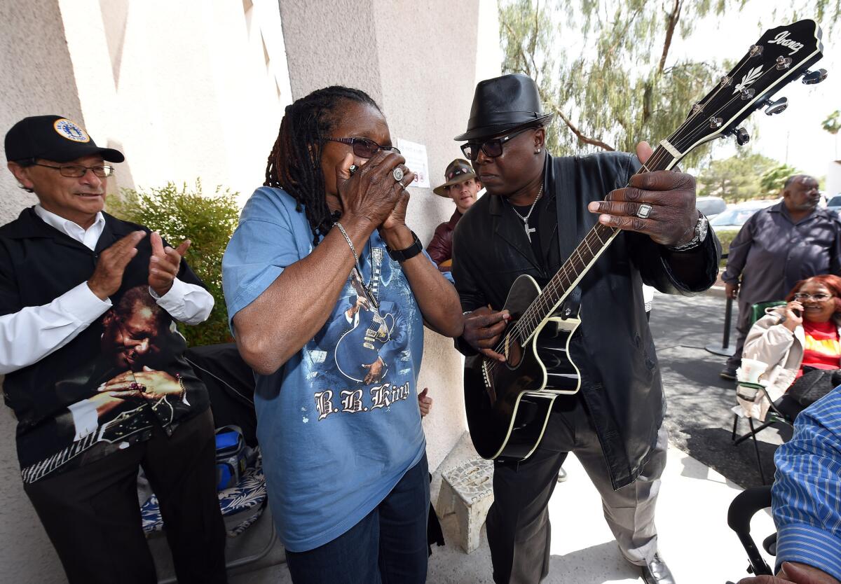 Georgia Jackson of California and Jerry Wilson of Nevada play blues music outside the mortuary where fans paid their respects to B.B. King on Friday.