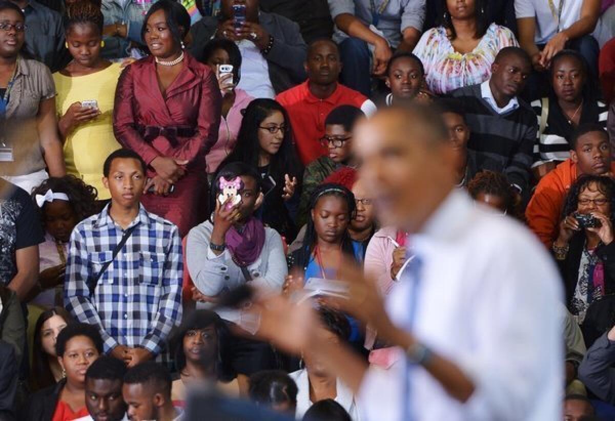 Some opponents of the healthcare reform law hope the individual mandate will turn off younger voters to the Democratic Party. Above, audience members watch last month as President Obama speaks on the Affordable Care Act at Prince Georges Community College in Maryland.