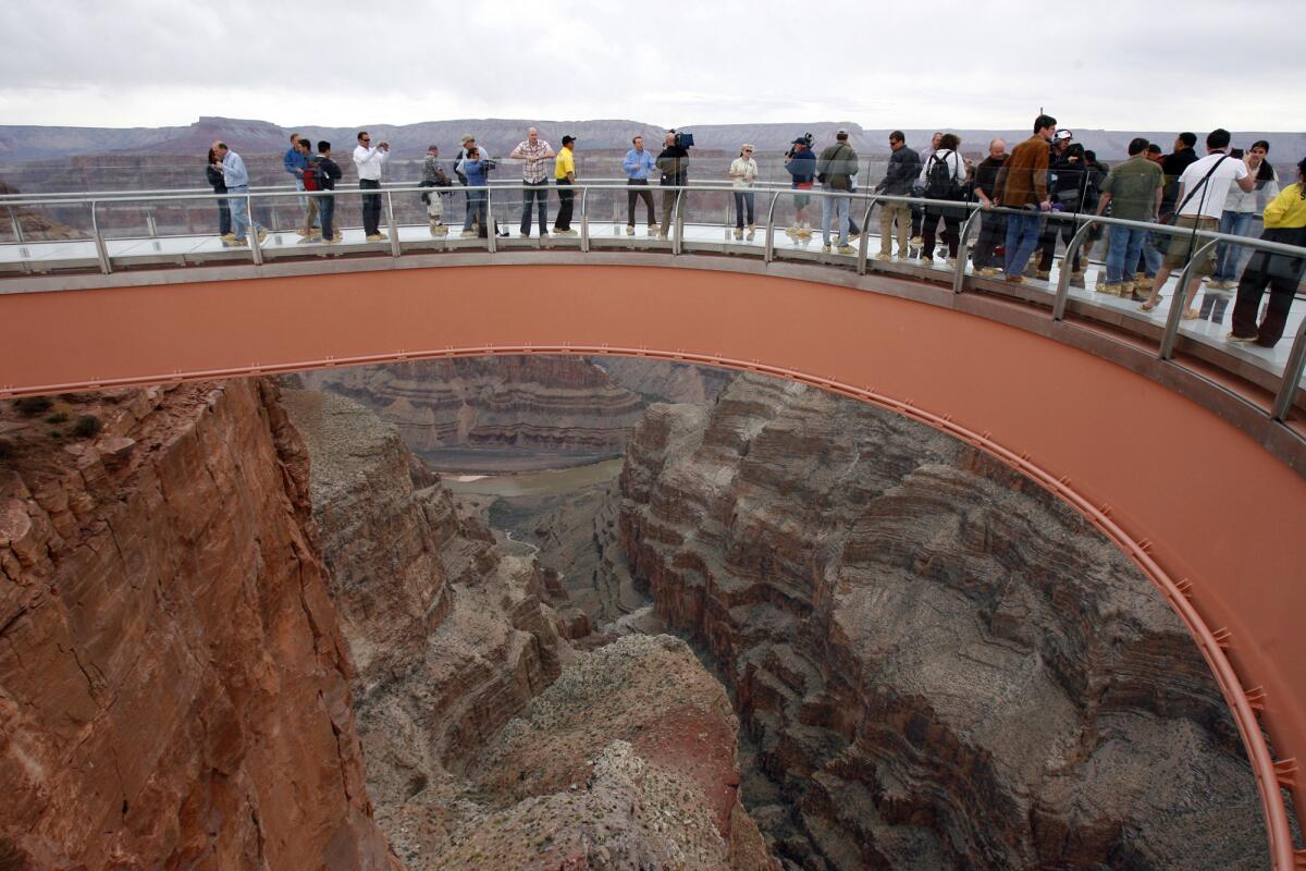 People walk on the Grand Canyon Skywalk on the Hualapai Indian Reservation in Arizona in this 2007 photo. A newly paved road, which cuts down on time and vehicle damage, cost more than $30 million to complete.