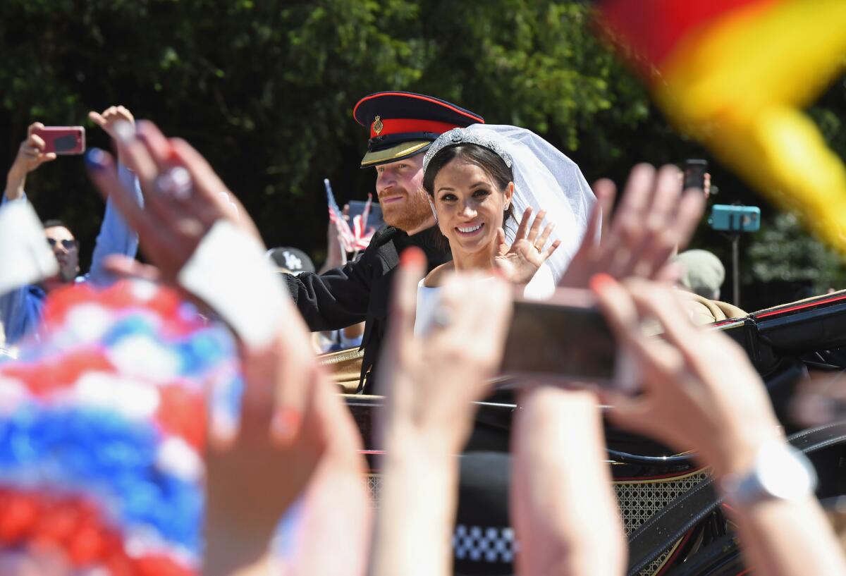 Prince Harry, Duke of Sussex, and Meghan, Duchess of Sussex, leave Windsor Castle after their wedding ceremony.