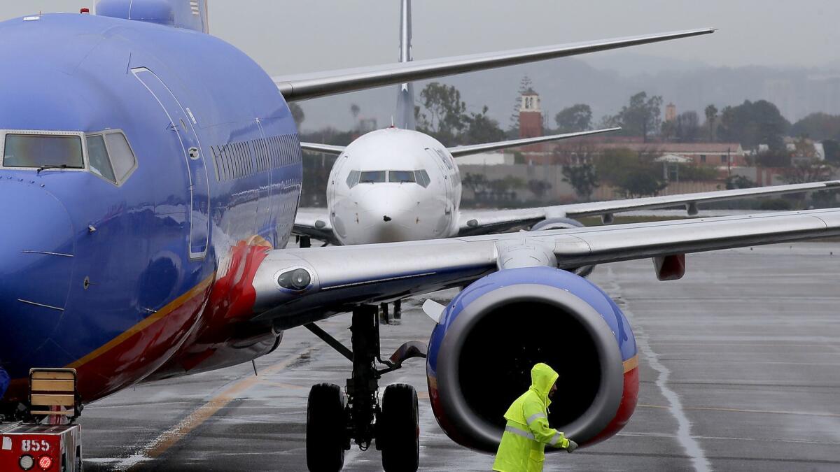 Jetliners line up to park at gates at Terminal 1 at Los Angeles International Airport.