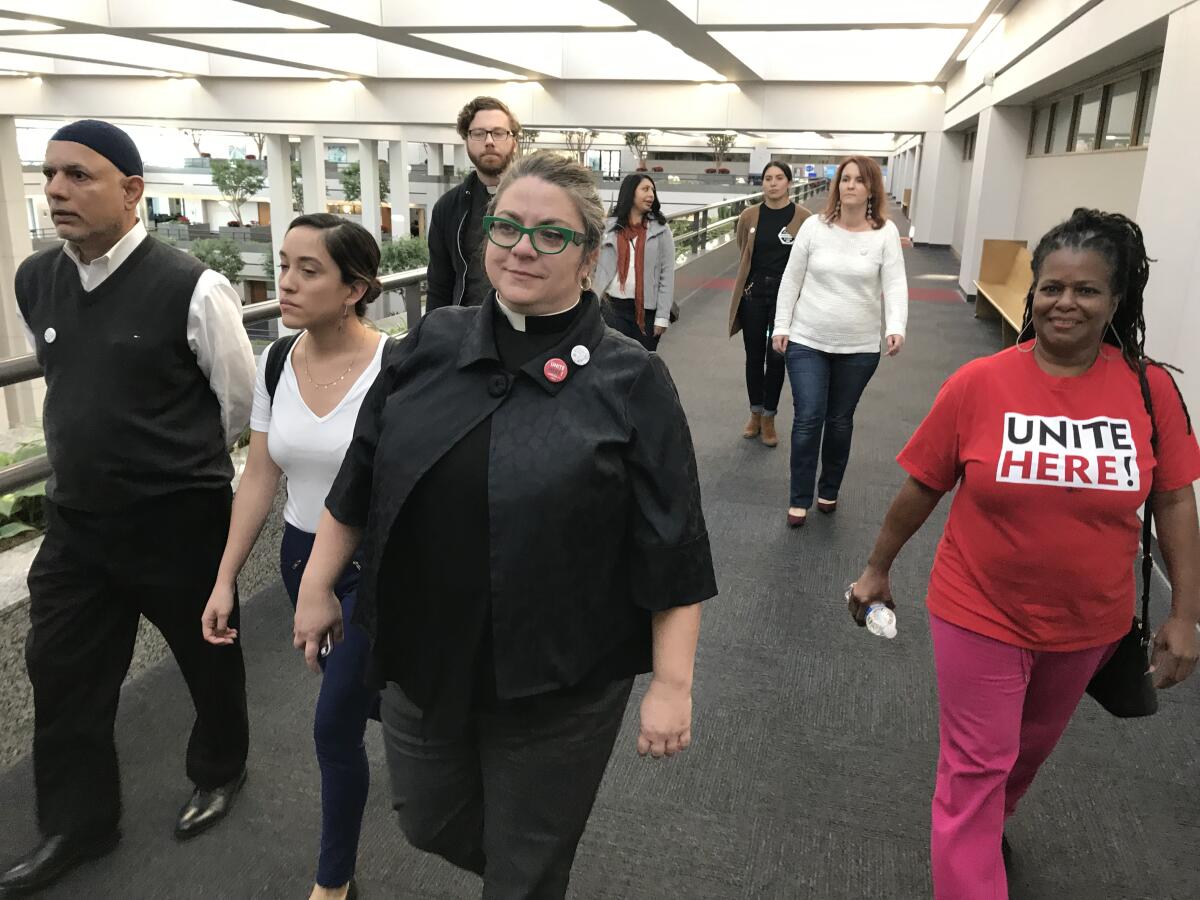 Union members and clergy supporting Unite Here met with Loyola Marymount University officials in Los Angeles on Monday, Dec. 16, 2019, to push for a resolution to a contract dispute that is threatening this week's Democratic presidential debate.