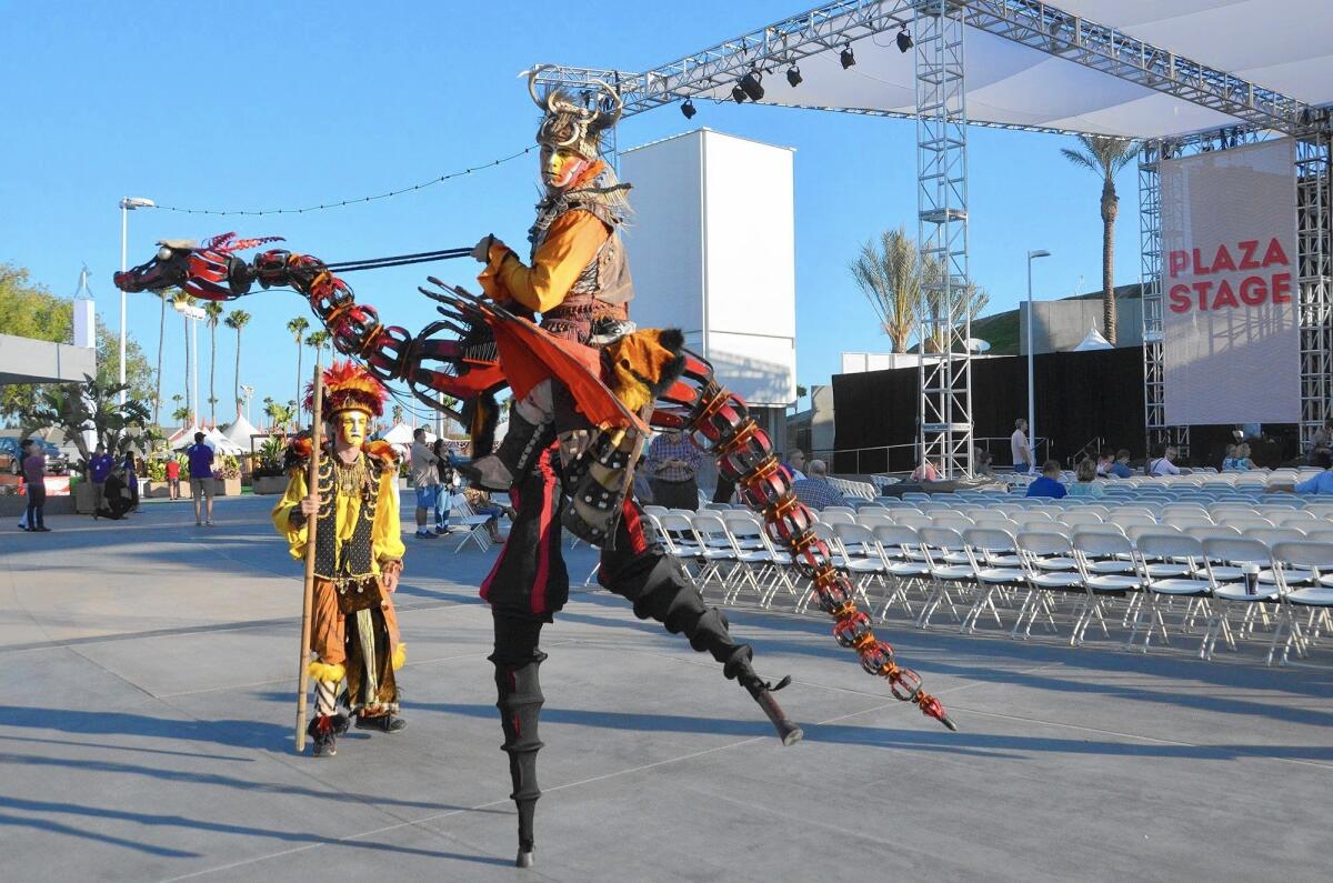A dragon stilt walker and slayer entertain attendees of the Orange County Fair on Thursday evening.